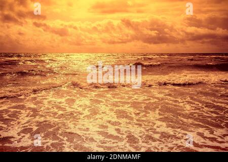 Seascape. Stormy sea at dramatic sunset. Landscape with ocean and bright evening cloudy sky Stock Photo