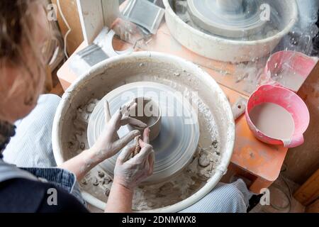 Woman using potters wheel Stock Photo