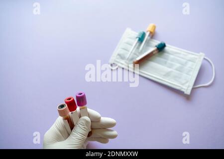 Hand in surgical glove holding medical samples Stock Photo