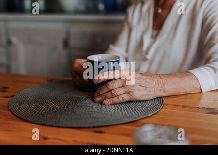 Womans hands holding mug Stock Photo