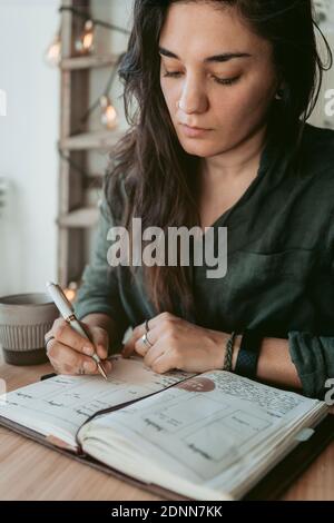 Woman taking notes in her diary Stock Photo