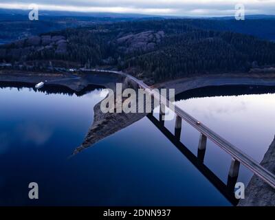 Aerial landscape view of bridge over reservoir, Harz mountains in Lower Saxony, Germany. Calm and dark blue water of the Okertalsperre, Oker Dam. Stock Photo