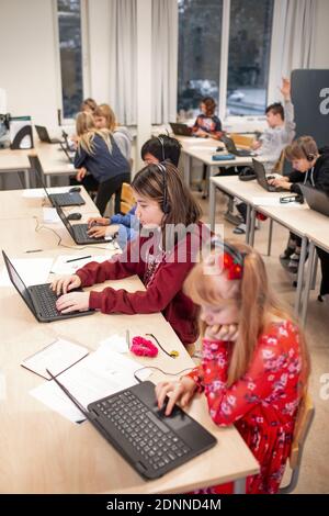 Children in classroom using laptops Stock Photo