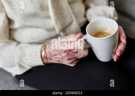Womans hands holding mug Stock Photo