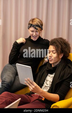 Young friends using digital tablet Stock Photo