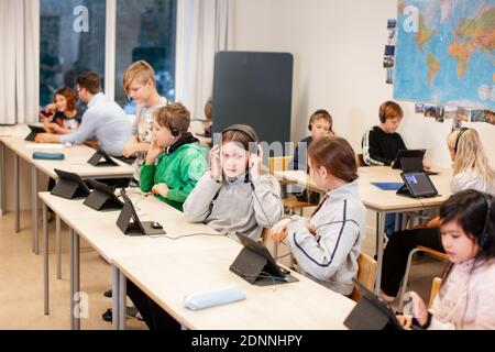 Children in classroom using digital tablet Stock Photo