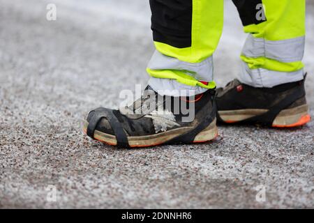 Person wearing working boots Stock Photo