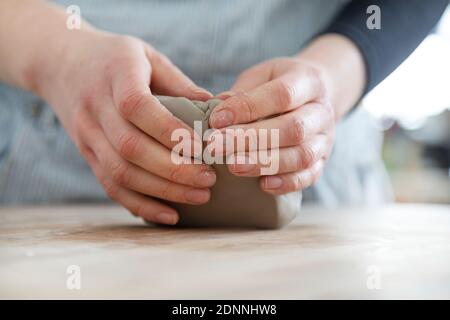 Womans hands modeling clay Stock Photo