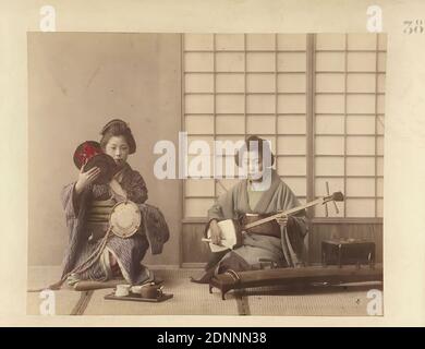 Two Japanese women playing instruments, albumin paper, black and white positive process, hand colored, image size: height: 18.80 cm; width: 24.00 cm, inscribed: recto o. r.: printed in blue: 38, travel photography, portrait photography, woman, young woman, girl, folk costume, regional costume Stock Photo