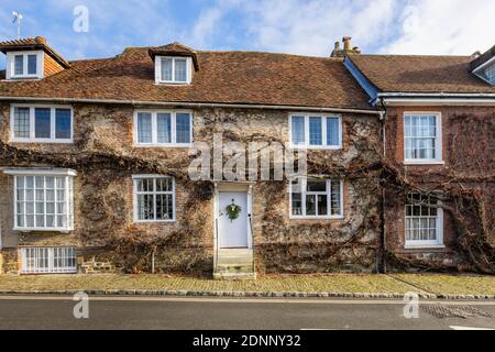 Georgian style terraced cottage in Church Hill, Midhurst, West Sussex, in winter with a seasonal wreath on its white front door Stock Photo