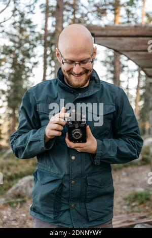 Smiling man holding camera Stock Photo