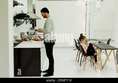 Father with children in kitchen Stock Photo