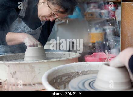 Woman using potters wheel Stock Photo