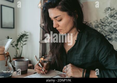 Woman making notes in diary Stock Photo