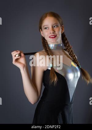 Redhead Teen Majorette Girl with Pigtails Posing in Studio Stock Photo