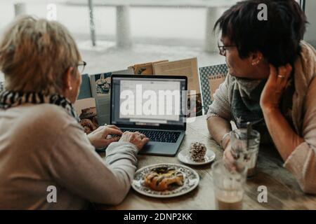 Women using laptop in cafe Stock Photo