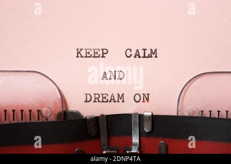 Keep calm and dream on phrase written with a typewriter. Stock Photo