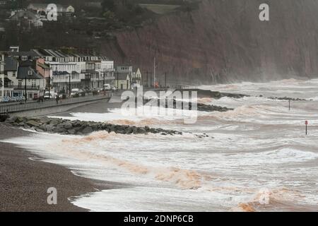 Sidmouth, Devon, UK.  18th December 2020.  UK Weather.   Rough seas crash ashore on the beach at Sidmouth in Devon on a morning of strong gusty winds and rain.  Picture Credit: Graham Hunt/Alamy Live News Stock Photo
