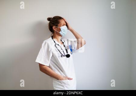 Female doctor wearing protective face mask Stock Photo