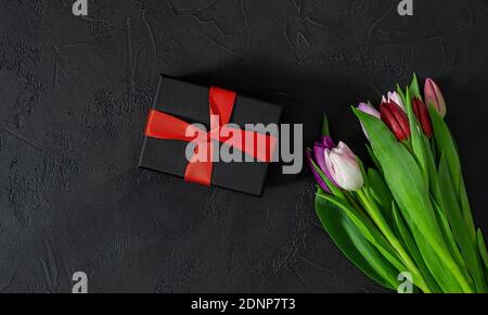Happy Valentines Day, Women's Day, Mother's Day concept. Gift box and Tulip flowers. Stock Photo