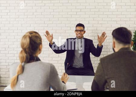 Charismatic candidate describing his work experience in job interview with HR managers Stock Photo
