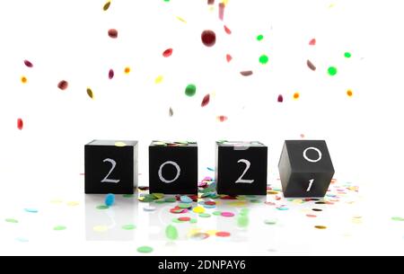 Wooden Blocks With 2021 Number On Table and confetti isolated on white Stock Photo