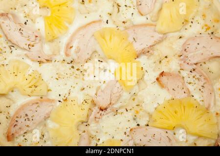 Texture Delicious Hawaiian pizza served on a wooden plate, ingredients garlic sauce, mozzarella cheese, smoked chicken, canned pineapples on white. Pizzeria promotion poster. Stock Photo
