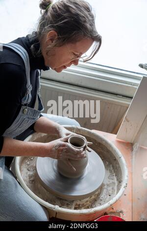 Woman using potters wheel Stock Photo