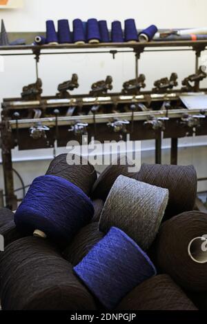 Group of bobbin thread cones on a warping machine in a textile mill ...