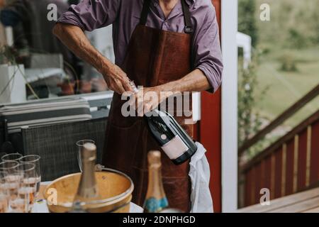 Man opening champagne bottle Stock Photo