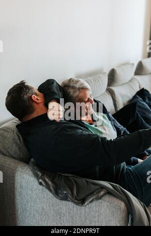 Mature couple sitting on sofa Stock Photo