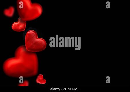 Red flying hearts isolated on black background. Valentines day greeting card with space for text. Stock Photo