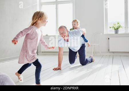 Father playing with children at home Stock Photo