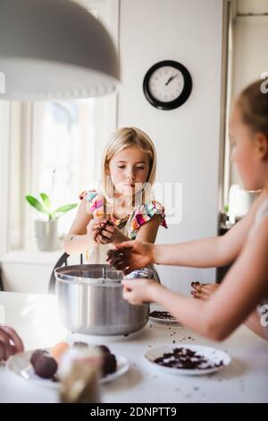 Girls making food in kitchen Stock Photo