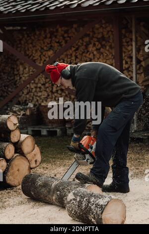 Senior man using chainsaw Stock Photo