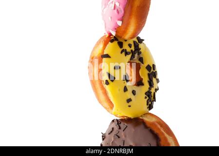 Stack of assorted donuts isolated on white background. Stock Photo