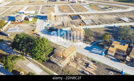 Multiple wooden houses under construction at master planned community suburbs Dallas, Texas, America. Typical two story single family homes on slab fo Stock Photo