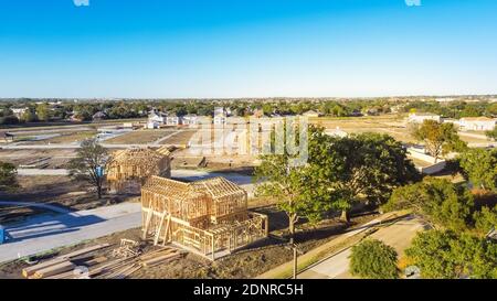 Aerial view wooden houses under construction in master planned community suburbs Dallas, Texas, America. Typical two story single family home on slab Stock Photo