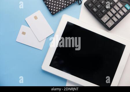 top view of digital tablet, credit cards with office suppliers on table  Stock Photo