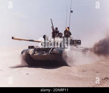 Iraqi Army Russian Chinese T55 tank, captured and crewed by British Army soldiers of 1st Queens Dragoon Guards and REME. Kuwait. Gulf War 1991 Stock Photo