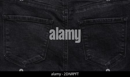 Background of the back pockets of black jeans Stock Photo
