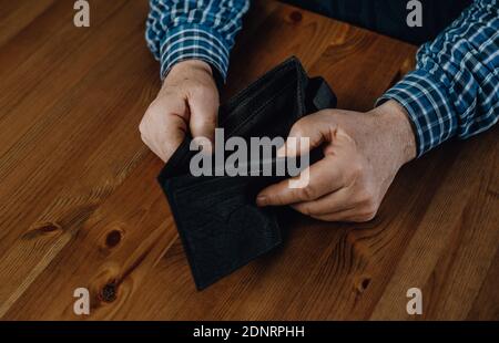 Close up of senior man wihout money and an empty wallet, economic crisis concept Stock Photo