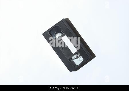 Video cassette on a white background. Retro technology. Photo with shadows, hard light Stock Photo
