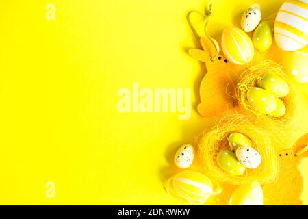 Easter egg and Easter bunny arrangement on a yellow background Stock Photo