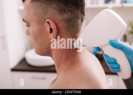 Cropped shot of a man getting laser hair removal treatment at