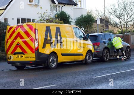 AA recovery engineer attended to a breakdown car on roadside on a cold day, London, Greenwich Stock Photo