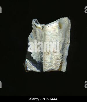 Fragment of a ribbed bowl, Glass, pressed, blown into shape, Glass, Total: Height: 3.4 cm; Width: 2.7 cm; Depth: 0.7 cm, Drinking and barware, Burial objects, Early Imperial Period, Roman Antiquity, A slight curvature of the glass fragment and the two preserved ribs allow the attribution to a ribbed bowl. The dark brown glass is heavily corroded and covered with a white, mother-of-pearl layer. Due to the elaborate manufacturing process and its fragility, glass was considered one of the luxury articles of antiquity Stock Photo