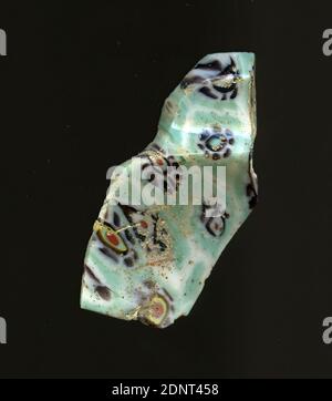 Fragment of a vessel, glass, millefiori technique, Total: Height: 4.90 cm; Width: 2.40 cm, container, storage, kitchen work, drinking and bar utensils, floral ornaments, Early Imperial Period, A slight curvature of the glass fragment as well as a bend allow the attribution to a vessel, probably a bowl Several flowers in millefiori technique can be seen on a turquoise ground. Stock Photo