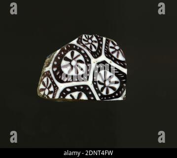 Mosaic glass fragment, glass, pressed, cut, glass, Total: Height: 2.00 cm; Width: 2.70 cm; Depth: 0.30 cm, floor coverings, wall decorations, flowers, Early Imperial Period, Purple flowers are inserted into the white ground. They consist of a punctiform white core with a dark edge, eight petals and a broad dark outer circle with white dots. In Roman times, colored, ornamented glass was used for vessels, mosaics, wall decorations and furniture ornaments Stock Photo