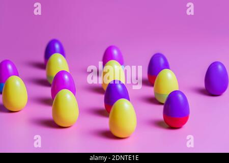 Colorful Plastic Easter Eggs on pink background Stock Photo